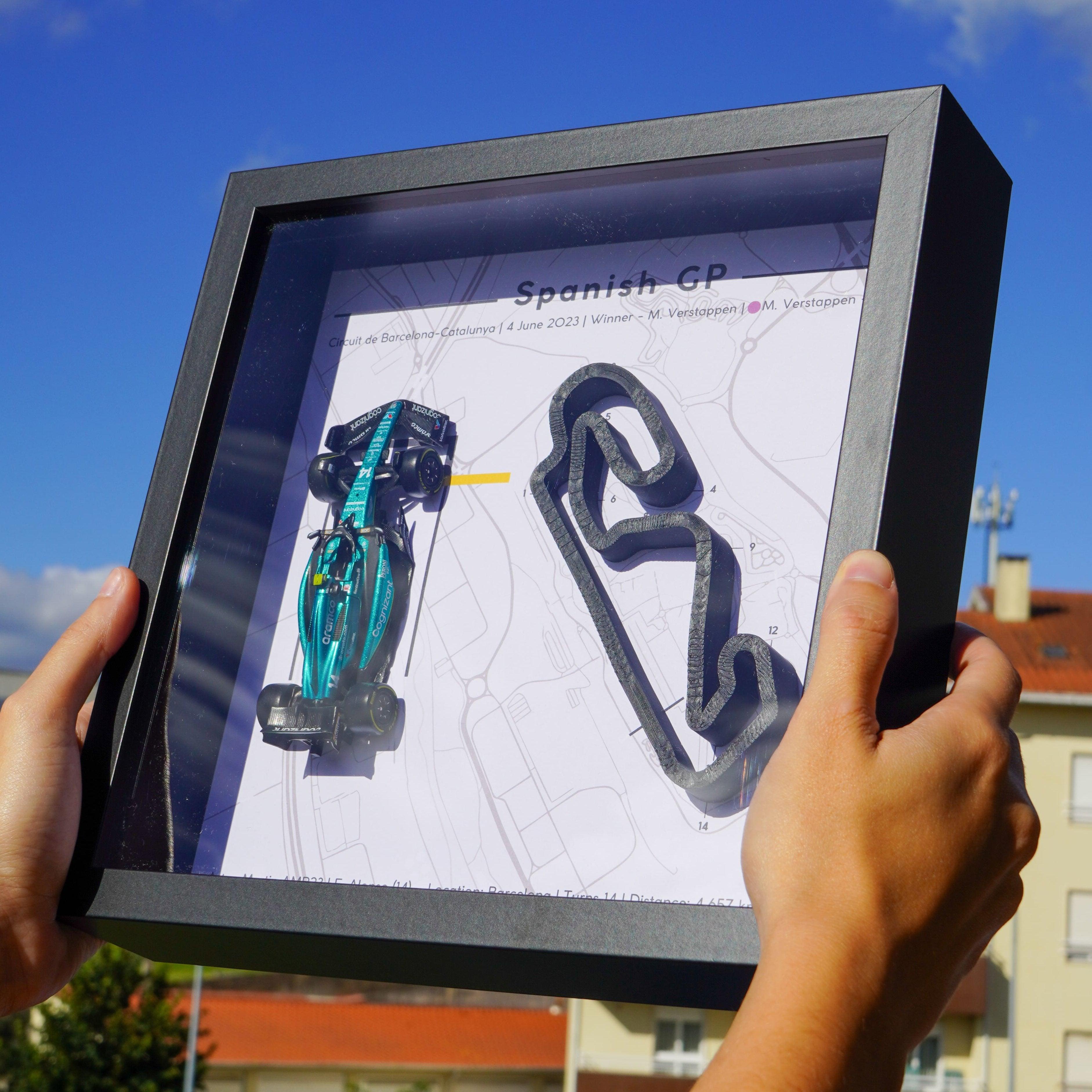 F1-themed frame featuring a 1:43 scale Alonso's car on the Spanish GP track. Includes a 3D-printed track replica with real elevation changes and a satellite map background.