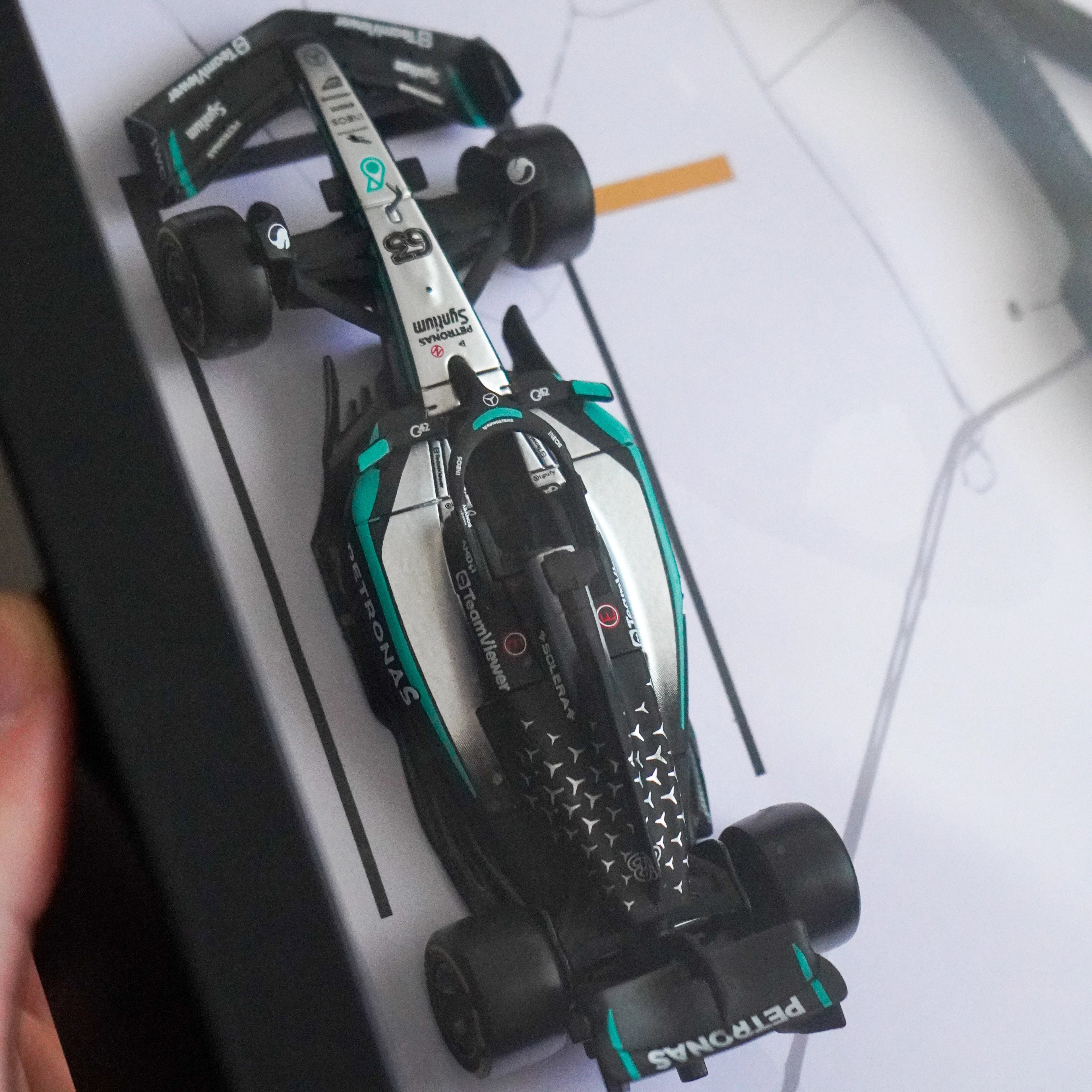 Model Formula 1 car on a printed track map