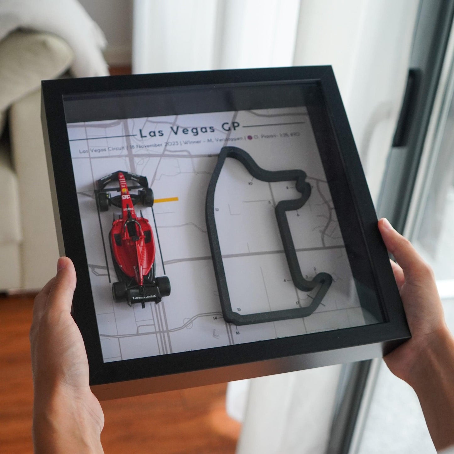 F1-themed frame featuring a 1:43 scale Leclerc's car on the Las Vegas GP track. Includes a 3D-printed track replica with real elevation changes and a satellite map background