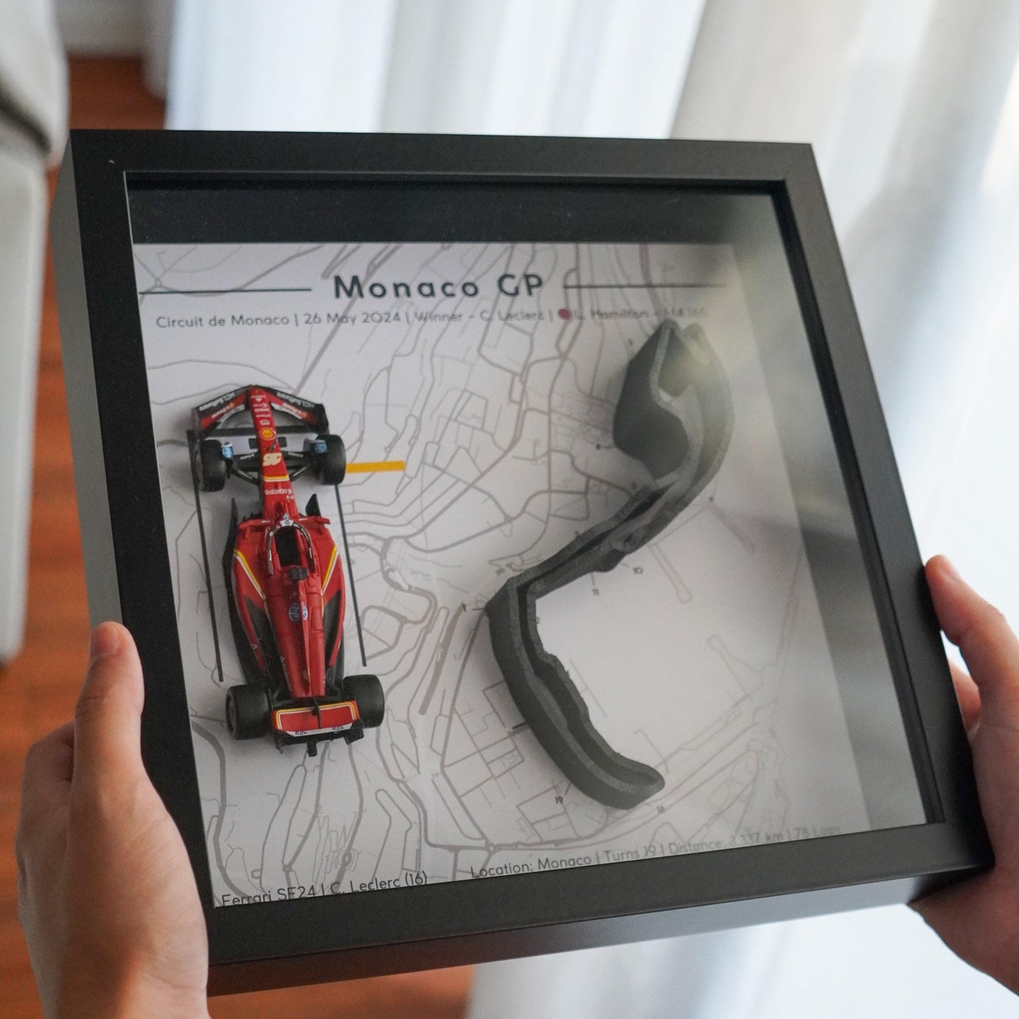 F1-themed frame featuring a 1:43 scale Leclerc's car on the Monaco GP track. Includes a 3D-printed track replica with real elevation changes and a satellite map background