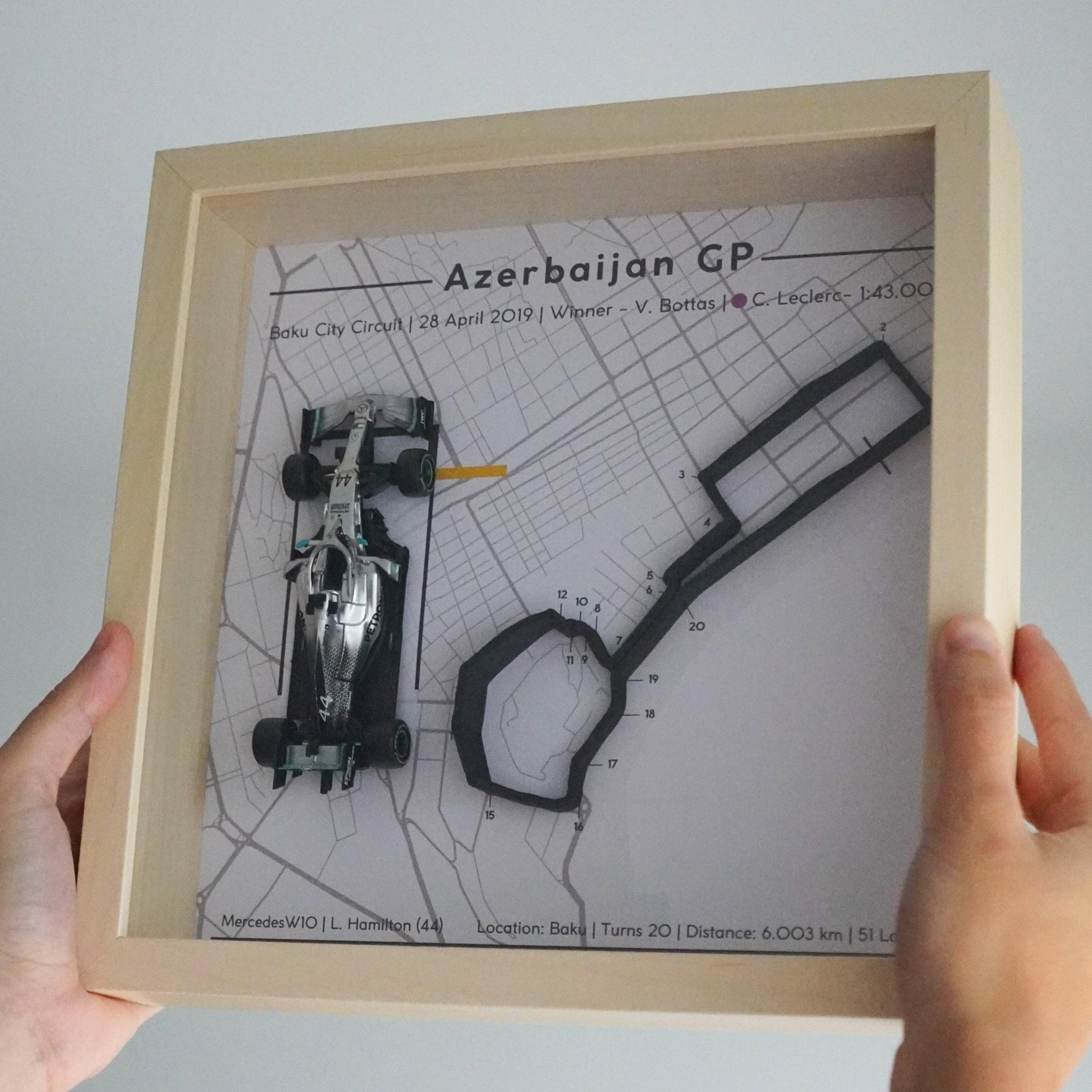 F1-themed frame featuring a 1:43 scale Hamilton's car on the Azerbaijan GP track. Includes a 3D-printed track replica with real elevation changes and a satellite map background