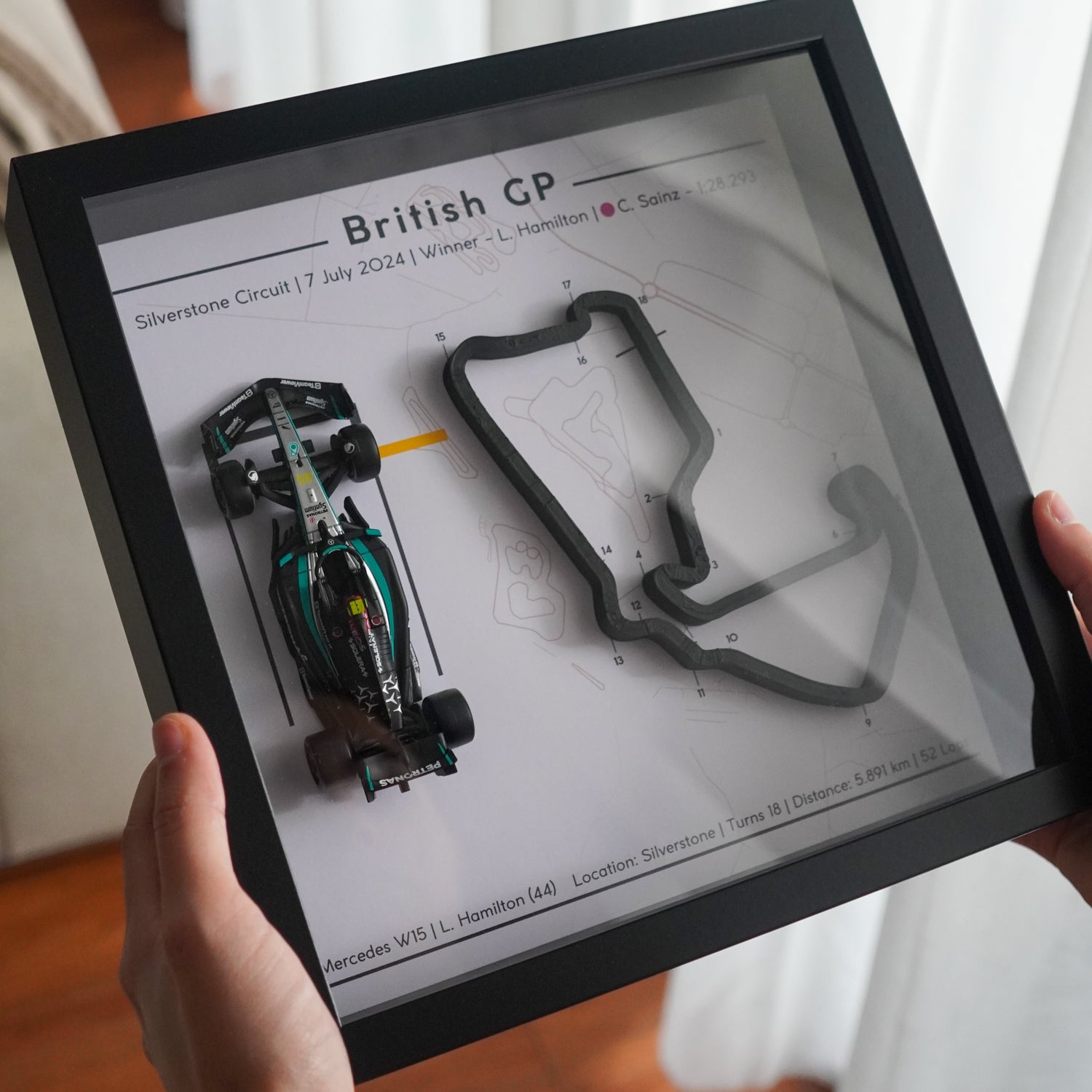 F1-themed frame featuring a 1:43 scale Hamilton's car on the British GP track. Includes a 3D-printed track replica with real elevation changes and a satellite map background