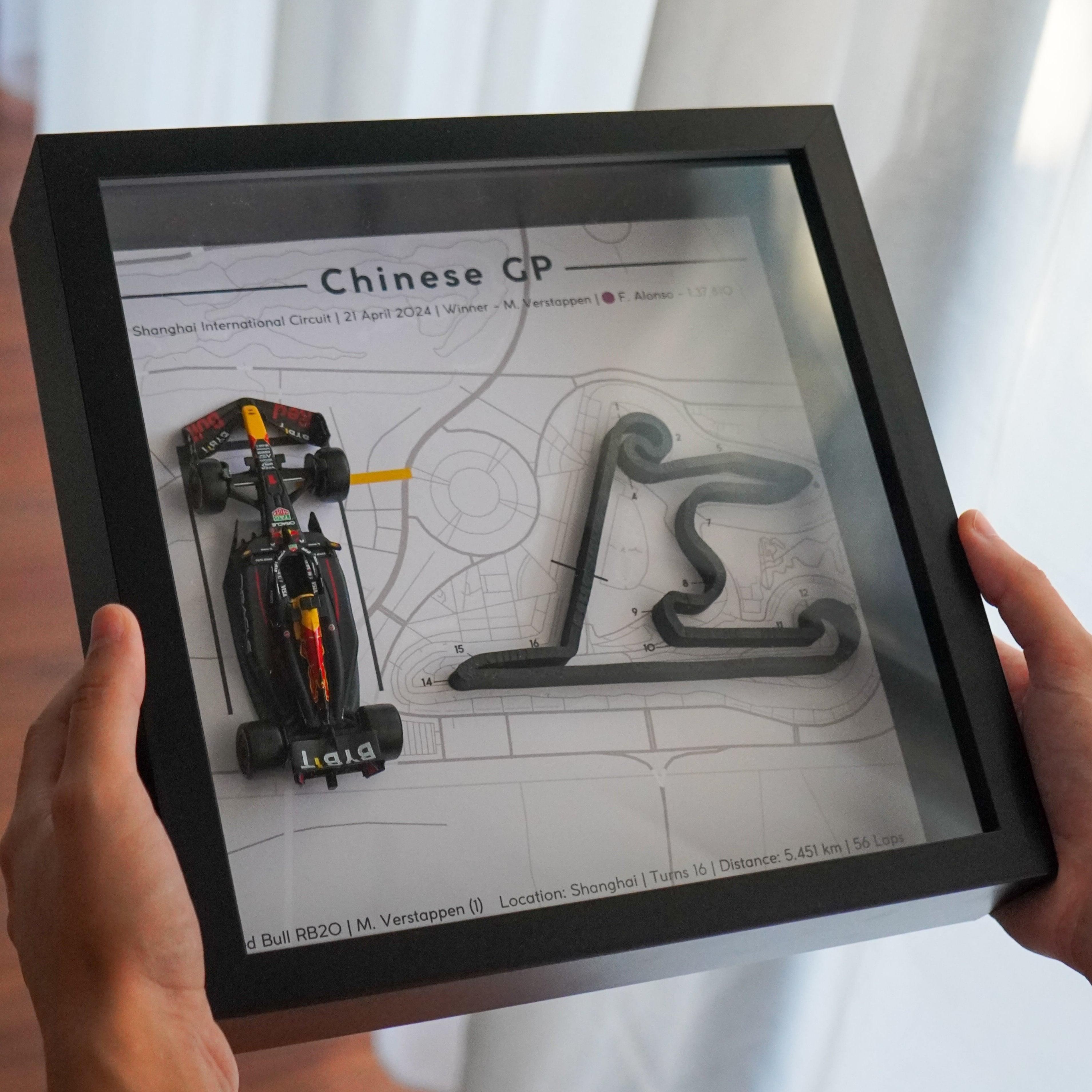 F1-themed frame featuring a 1:43 scale Max Verstappen's car on the Chinese GP track. Includes a 3D-printed track replica with real elevation changes and a satellite map background