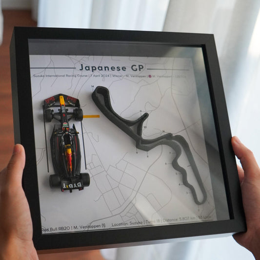 F1-themed frame featuring a 1:43 scale Max Verstappen's car on the Japanese GP track. Includes a 3D-printed track replica with real elevation changes and a satellite map background