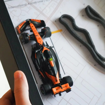 F1-themed frame featuring a 1:43 scale Norris's car on the Miami GP track. Includes a 3D-printed track replica with real elevation changes and a satellite map background