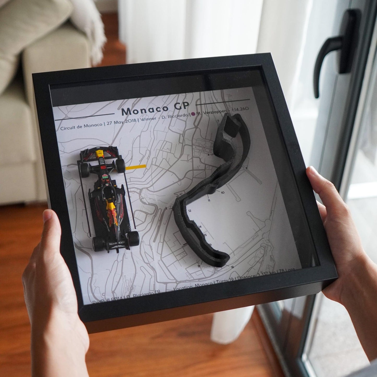 F1-themed frame featuring a 1:43 scale Daniel Ricciardo's car on the Monaco GP track. Includes a 3D-printed track replica with real elevation changes and a satellite map background