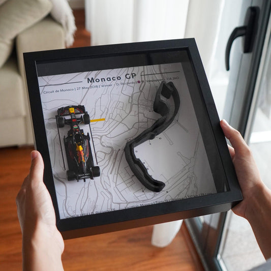 F1-themed frame featuring a 1:43 scale Daniel Ricciardo's car on the Monaco GP track. Includes a 3D-printed track replica with real elevation changes and a satellite map background