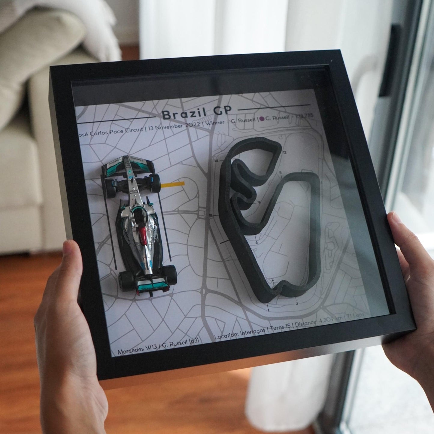 F1-themed frame featuring a 1:43 scale Russell's car on the Brazil GP track. Includes a 3D-printed track replica with real elevation changes and a satellite map background